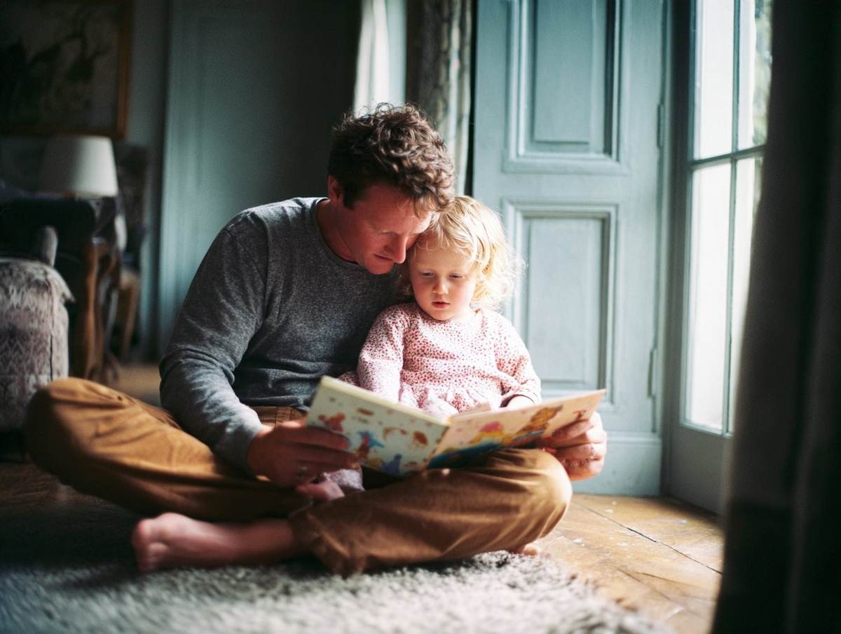 A father reading a book with his daughter